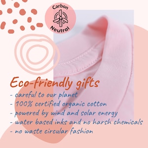 May include: A close-up of a light pink garment collar. The image includes text that reads "Eco-friendly gifts" and details about the product's eco-friendly features, such as organic cotton and wind/solar energy.