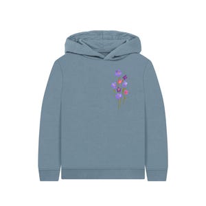 May include: A blue-grey hoodie with a floral design. The hoodie features a hood and long sleeves. The floral design includes purple, pink, and red flowers with green stems. The hoodie is made of a soft material.
