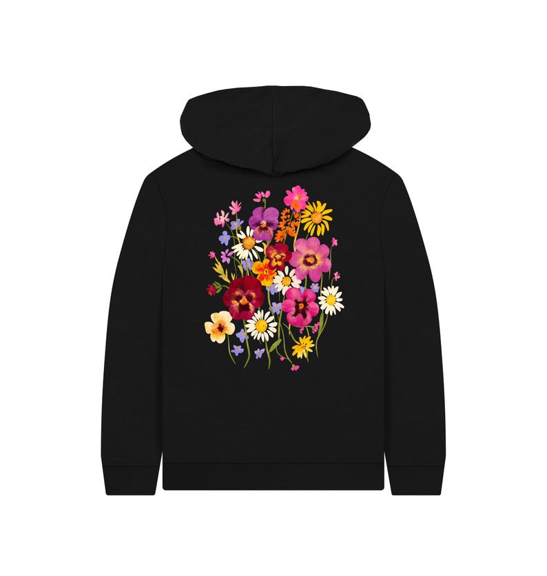 May include: Black hoodie featuring a vibrant floral design on the back. The colorful bouquet includes pink, purple, yellow, and white flowers. The hoodie has a drawstring hood and a kangaroo pocket.