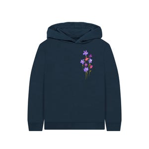 May include: A navy blue hoodie featuring a small floral design on the upper left chest. The flowers are a mix of purple, pink, and red, with green stems. The hoodie has a hood and long sleeves, suitable for casual wear.