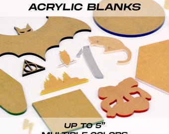 May include: Custom laser-cut acrylic blanks in various shapes, including a bat, cat, owl, and bow. The blanks are up to 5 inches in size and available in multiple colors. The text on the image reads "Custom Laser Cut Acrylic Blanks".
