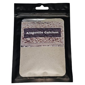 May include: A white resealable bag with a label that reads "The Great Invertebrate Aragonite Calcium". The label also states "Can be used with geckos, desert tree dwelling invertebrates, chickens and more. Completely renewable. Sourced in the Bahamas."