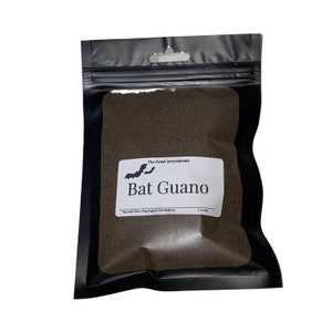 May include: A black resealable bag filled with brown bat guano. The bag has a white label that reads "The Great Invertebrate Bat Guano Naturally Occurring Organic Soil Additive 1 ounce".
