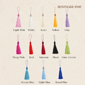 May include: A collection of twelve decorative tassels arranged in three rows, each featuring a hanging loop and labeled with its color: light pink, white, ivory, yellow, lilac, deep pink, red, maroon, black, lime green, ocean blue, light blue, and royal blue. The text BESTMADE4YOU appears at the top right.