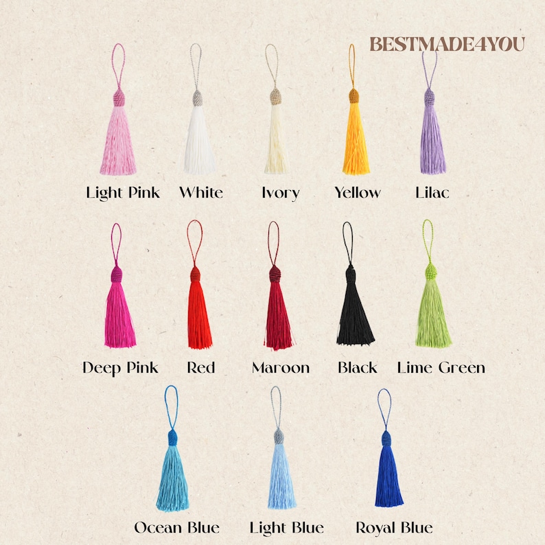May include: A collection of twelve decorative tassels arranged in three rows, each featuring a hanging loop and labeled with its color: light pink, white, ivory, yellow, lilac, deep pink, red, maroon, black, lime green, ocean blue, light blue, and royal blue. The text BESTMADE4YOU appears at the top right.