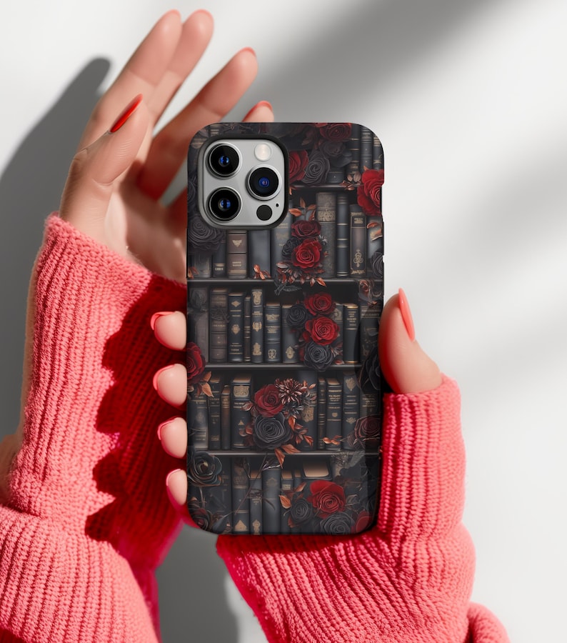 May include: A black phone case with a design of a bookshelf filled with books and red roses.