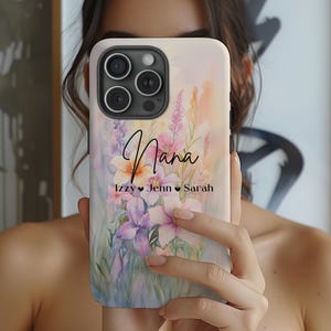 May include: A white phone case with a watercolor floral design and the word "Nana" in black script. The names "Izzy", "Jenn", and "Sarah" are written below in black with hearts between each name.