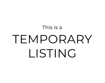May include: A black and white sign with the text "This is a TEMPORARY LISTING" in a bold, sans-serif font.