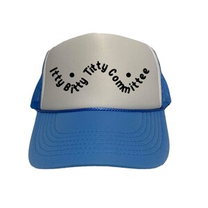 Op de afbeelding: Een truckerpet met een lichtblauwe klep en een wit voorpaneel. De tekst "Itty Bitty Titty Committee" is in het zwart op de voorkant gedrukt. De pet heeft een blauwe mesh achterkant.