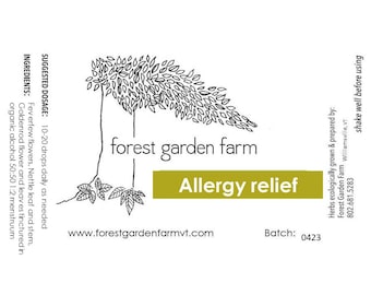 May include: A black and white illustration of a forest with the text "forest garden farm" and "Allergy relief" in a yellow rectangle. The text "www.forestgardenfarmvt.com" and "Batch: 0423" are also included. The text "Herbs ecologically grown & prepared by: Forest Garden Farm Williamsville, VT 802.681.5283 shake well before using" is on the right side of the image.