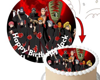 May include: A round cake topper with a group of anime characters in black cloaks with red cloud designs, set against a red background. The words "Happy Birthday Black" are written in white. The cake is decorated with white frosting.
