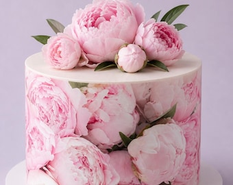 May include: A round cake decorated with pink peony flowers. The cake's sides are covered in a floral print of pink peonies. The top of the cake is white and adorned with fresh pink peony blooms and green leaves. The cake sits on a white cake stand.