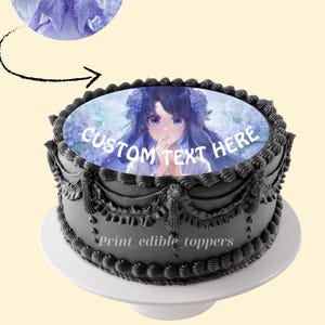Può includere: Una torta personalizzata con glassa nera e un supporto bianco. La torta presenta una decorazione fotografica commestibile circolare con un'illustrazione in stile anime e la scritta "CUSTOM TEXT HERE". Il testo "Print edible toppers" è anch'esso visibile.