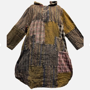 May include: A white ceramic mug with a black handle and the text "But First, Coffee" in a bold, black font. The mug is likely 11 ounces in size and sits on a white surface.