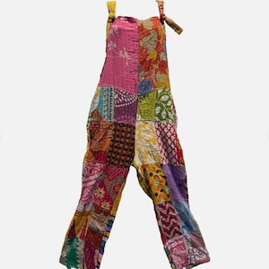 May include: A patchwork jumpsuit in a variety of colors, including pink, orange, green, and purple. The jumpsuit features adjustable tie straps and a loose, comfortable fit. The fabric appears to be a mix of patterned textiles.