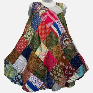 May include: A sleeveless A-line dress featuring a vibrant patchwork design composed of various fabric squares. The garment displays a multitude of colors including red, blue, green, brown, and white, with diverse floral, geometric, and paisley patterns.