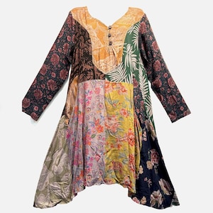 May include: A long-sleeved dress featuring a patchwork design with various floral and botanical patterns in shades of yellow, green, black, and pink. The bodice includes a V-neckline with three brown buttons and a light orange patterned panel.
