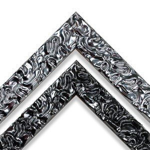 May include: A pair of nested corner sections of a picture frame featuring a highly reflective, metallic silver finish. The surface is characterized by a raised, fluid, and organic texture that creates deep shadows and bright highlights across the frame.