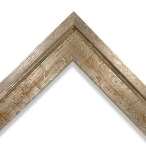May include: A corner section of a silver and gold picture frame. The frame has a textured, distressed finish with visible wood grain. The frame's design is angled, showcasing its corner construction and decorative details.