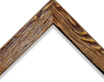 May include: Close-up of a wooden picture frame corner. The frame has a dark brown finish with a prominent wood grain pattern and yellow highlights. The frame is angled, showcasing its construction and texture against a white background.