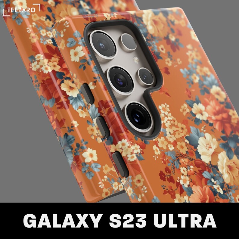 May include: A floral phone case for the Samsung Galaxy S23 Ultra. The case features a vibrant orange background with a pattern of colorful flowers.