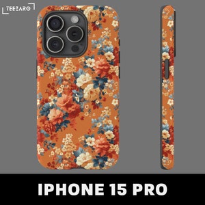 May include: A floral phone case for the iPhone 15 Pro. The case features a bright orange background with a repeating pattern of red, orange, yellow, and blue flowers.