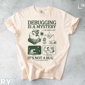 May include: Ivory t-shirt with the words "Debugging is a Mystery" and a graphic of a duck wearing glasses. The shirt also features a flowchart and the phrase "It's Not a Bug".