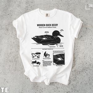 White t-shirt featuring a diagram of a wooden mallard duck decoy.