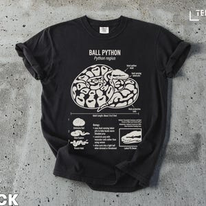 T-shirt graphic of a ball python with anatomical labels and biology facts.