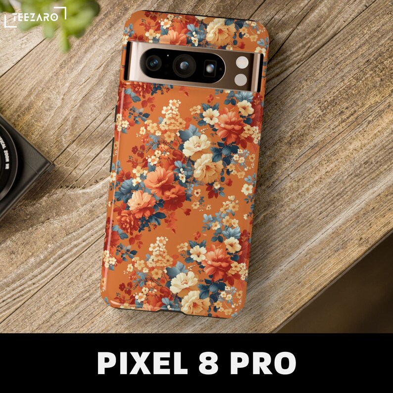 May include: A floral phone case with a brown background and orange, white, and blue flowers. The case is designed for a Pixel 8 Pro phone.