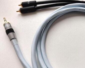May include: A light blue audio cable with a 3.5mm jack and RCA connectors. The cable is coiled and has black and gold connectors. The image is a close-up of the cable against a white background.