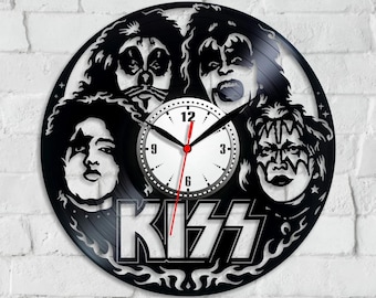 May include: Black vinyl record clock featuring the faces of the band members of KISS. The clock has a white clock face with black numbers and hands. The word "KISS" is displayed in white with a flame design.