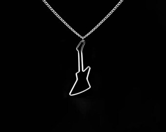 May include: A silver-colored necklace with a pendant shaped like an electric guitar. The guitar pendant is a simple outline, suspended from a delicate chain. The background is solid black, highlighting the necklace.