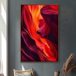 May include: Abstract art print featuring a swirling pattern of red, orange, and purple hues. The colors create a dynamic and energetic feel, reminiscent of a canyon landscape.
