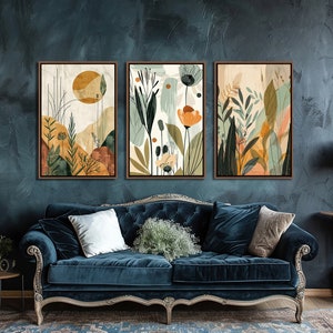 May include: Three framed abstract art prints with a nature theme. The prints feature a variety of colours, including green, blue, yellow, and orange. The prints are arranged in a row on a wall, above a blue velvet sofa.