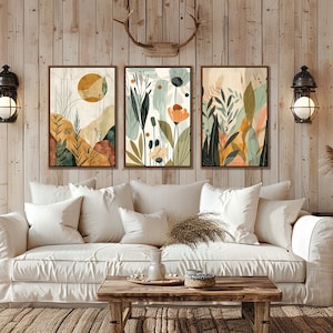 May include: Three abstract art prints with a nature theme. The prints feature a variety of colours, including green, yellow, orange, and brown. The prints are framed in a simple, modern style.