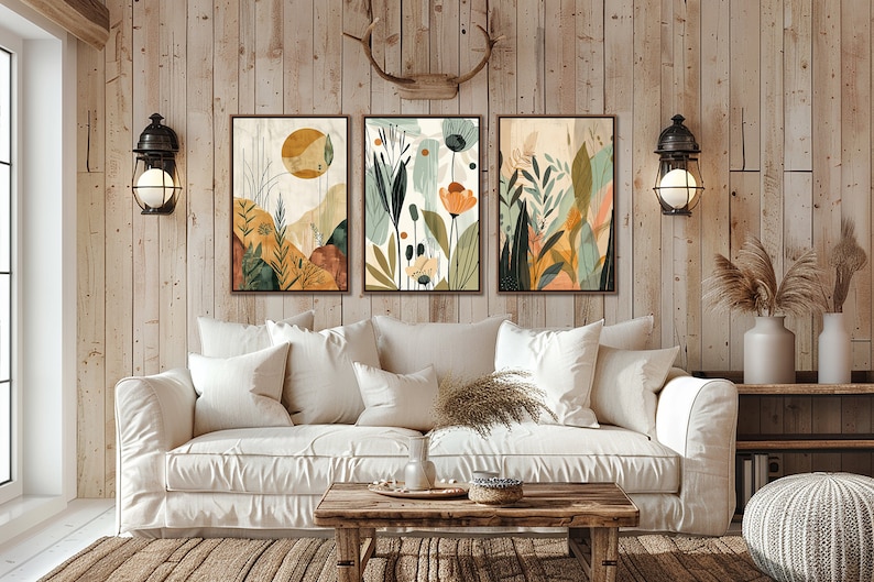 May include: Three abstract art prints with a nature theme. The prints feature a variety of colours, including green, yellow, orange, and brown. The prints are framed in a simple, modern style.