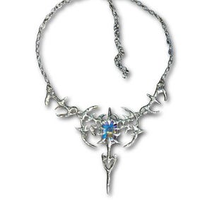 May include: A silver-toned necklace with an intricate, spiky design. The pendant features a central, multi-colored gemstone and a long, pointed drop. The necklace has a chain closure.