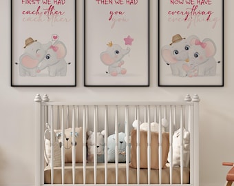 May include: Three framed wall art prints featuring cartoon elephants. The first shows two elephants with the text "FIRST WE HAD each other". The second shows a baby elephant with a star balloon and "THEN WE HAD you". The third shows a family with "NOW WE HAVE everything".