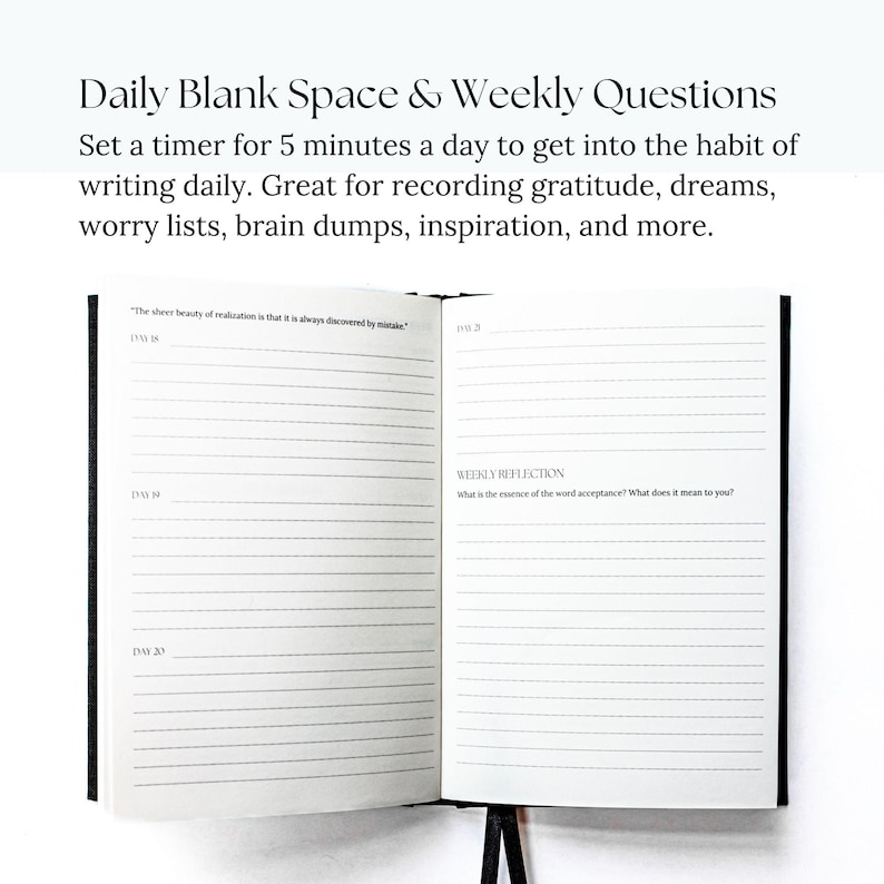 May include: A black and white journal with lined pages for daily writing prompts and weekly reflection questions. The text on the page reads "The sheer beauty of realization is that it is always discovered by mistake." and "What is the essence of the word acceptance? What does it mean to you?"