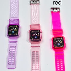 May include: Three Apple Watch bands in different colors: purple, pink, and bright pink. The bands are made of clear, flexible silicone with a textured pattern. Each band has a silver buckle.