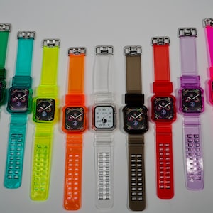 May include: A set of 10 colorful clear silicone watch bands for Apple Watch. The bands are in various colors, including blue, green, yellow, orange, red, purple, and pink. The bands have a clear, translucent design with a grid pattern.