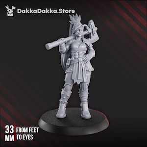 May include: A gray figurine of a female warrior holding a large axe, with a feather in her hair. The figurine is 33 mm from feet to eyes. The figurine is standing on a black circular base. The DakkaDakka.Store logo is in the upper left corner.