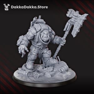 May include: A grey miniature figure of a warrior, kneeling on a base of debris. The figure is heavily armoured and wields a large, mechanical axe. The figure has a menacing expression and sharp teeth. The DakkaDakka.Store logo is in the top left corner.