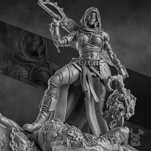 May include: A monochrome figurine of a warrior figure, wearing layered armour and a hooded cloak. The figure holds a chainsaw-like weapon and a grotesque head. The warrior stands on a rocky base with chains.