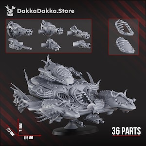 May include: A grey, unassembled model kit of a futuristic vehicle with various components, including weapons and armour. The model measures 17.3 cm long, 7.1 cm high, and 11.5 cm wide. The image also displays the text "36 PARTS" and the store name "DakkaDakka.Store".
