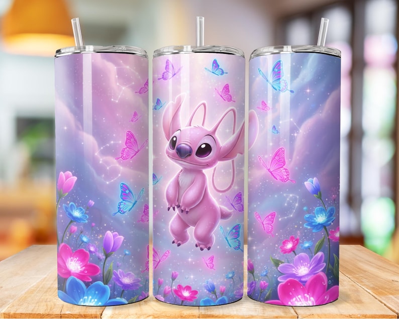 May include: A set of three stainless steel tumblers with a wraparound design featuring a pink cartoon character, butterflies, flowers, and a dreamy sky background. Each tumbler has a clear straw and lid.