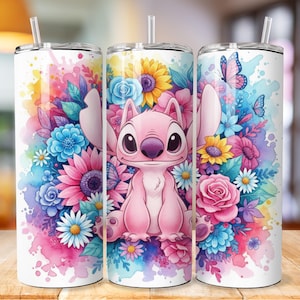 May include: Three white stainless steel tumblers with lids and straws. Each tumbler features a colourful watercolour design of a pink cartoon character surrounded by flowers and butterflies. The flowers include blue, pink, yellow, and white blooms.
