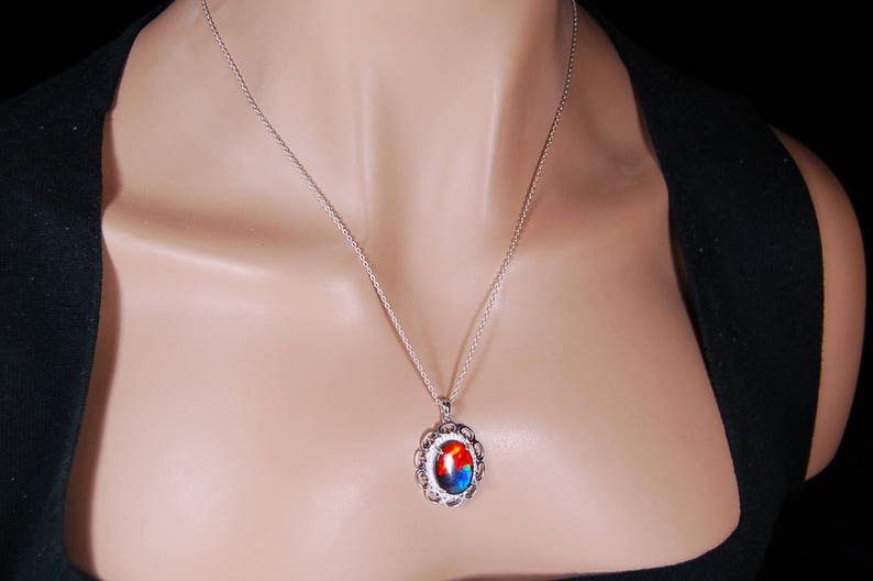 Spectacular Ammolite jewelry pendant rich in reds and blues.Grade AA.#123017