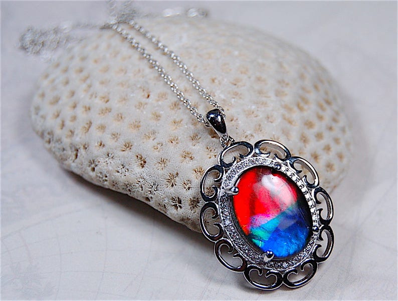 Spectacular Ammolite jewelry pendant rich in reds and blues.Grade AA.#123017